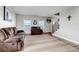 Spacious living room with plush seating, hardwood floors, and a decorative sign, creating a comfortable and inviting space at 35427 Welch Trl, Elizabeth, CO 80107