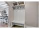 Functional mudroom area with a built-in bench, coat hooks, and overhead storage at 35427 Welch Trl, Elizabeth, CO 80107