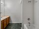 A bathroom featuring a vanity, toilet, and shower-tub combo with tile surround at 912 S Yampa St # 203, Aurora, CO 80017