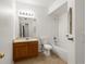 A bathroom featuring a vanity, toilet, and shower-tub combo with tile surround at 912 S Yampa St # 203, Aurora, CO 80017