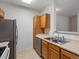 Kitchen with oak cabinets, stainless steel refrigerator, and double stainless steel sink at 912 S Yampa St # 203, Aurora, CO 80017