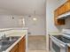 Kitchen view showcasing the cabinetry, stainless steel sink, and kitchen appliances, merging style with functionality at 912 S Yampa St # 203, Aurora, CO 80017