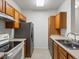 Kitchen with oak cabinets, stainless steel refrigerator, and electric range oven at 912 S Yampa St # 203, Aurora, CO 80017