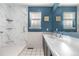 Updated bathroom with modern fixtures and a walk-in shower with marble-style tile at 21736 Silver Meadow Ln, Parker, CO 80138