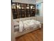 Cozy bedroom featuring built-in shelves, white cabinets, and a comfortable bed with a stylish marble-patterned comforter at 21736 Silver Meadow Ln, Parker, CO 80138