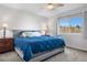 Cozy main bedroom featuring a ceiling fan, window, and a comfortable queen bed at 21736 Silver Meadow Ln, Parker, CO 80138