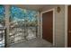 Balcony view showing pines, blue skies, dark metal rails and a brown door at 2896 W Riverwalk Cir # 204, Littleton, CO 80123