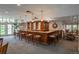 Community clubhouse with wooden bar, stools, and seating options at 2896 W Riverwalk Cir # 204, Littleton, CO 80123