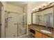 Well-lit bathroom featuring a glass shower door and granite vanity top at 2896 W Riverwalk Cir # 204, Littleton, CO 80123