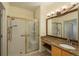 Bathroom featuring a shower and sink with granite countertops at 2896 W Riverwalk Cir # 204, Littleton, CO 80123