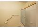 Updated bathroom with a glass shower door and accessibility handrails at 2896 W Riverwalk Cir # 204, Littleton, CO 80123