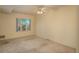 Inviting bedroom featuring a ceiling fan and bright natural light from the window at 2896 W Riverwalk Cir # 204, Littleton, CO 80123