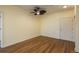 Bedroom featuring wood-look floors, a ceiling fan, and a closet at 2896 W Riverwalk Cir # 204, Littleton, CO 80123