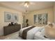 Bedroom with a window and balcony door with tan walls and neutral decor at 2896 W Riverwalk Cir # 204, Littleton, CO 80123