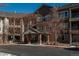 Brick building exterior with covered entrance and ample parking at 2896 W Riverwalk Cir # 204, Littleton, CO 80123