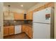 Kitchen with wood cabinets, granite counters at 2896 W Riverwalk Cir # 204, Littleton, CO 80123