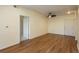 Bright living room featuring modern ceiling fan, light-colored walls, and wood-look laminate flooring at 2896 W Riverwalk Cir # 204, Littleton, CO 80123