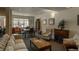 Common living room with fireplace, sofa, chairs, and dining table with seating at 2896 W Riverwalk Cir # 204, Littleton, CO 80123