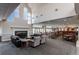 Large common room with fireplace, multiple seating options, and dining tables at 2896 W Riverwalk Cir # 204, Littleton, CO 80123