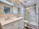 Elegant bathroom with marble shower and double vanity at 2368 W 119Th Ave, Denver, CO 80234