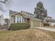 Two-story house with green siding, attached garage, and American flag at 2368 W 119Th Ave, Denver, CO 80234