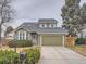Green two-story house with attached garage and landscaped front yard at 2368 W 119Th Ave, Denver, CO 80234