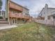 Two story house with a green exterior, deck, and fenced backyard at 2368 W 119Th Ave, Denver, CO 80234