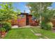 Cozy backyard patio with outdoor dining and lush green lawn at 1215 Jackson St, Denver, CO 80206