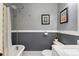 Grey bathroom featuring classic bathtub, marble top vanity, and framed artwork at 1215 Jackson St, Denver, CO 80206