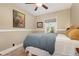 Bedroom with comfortable bed, side table, and natural light from a large window at 1215 Jackson St, Denver, CO 80206