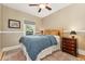 Cozy bedroom with a comfortable bed, wood floors, ceiling fan, and natural light at 1215 Jackson St, Denver, CO 80206