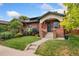 Charming brick home featuring a well-manicured lawn and inviting front porch at 1215 Jackson St, Denver, CO 80206