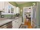 Kitchen with view into dining area showcasing stainless steel appliances and light countertops at 1215 Jackson St, Denver, CO 80206