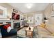 Comfortable living room featuring a stone fireplace, hardwood floors, and neutral decor at 1215 Jackson St, Denver, CO 80206