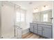 Elegant bathroom features a large shower, soaking tub, double vanity, and granite countertops at 1889 Water Birch Way, Castle Rock, CO 80108