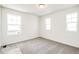 Bright bedroom with three windows and neutral carpet at 1889 Water Birch Way, Castle Rock, CO 80108