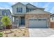 Beautiful two-story home with stone accents, gray siding, and attached garage at 1889 Water Birch Way, Castle Rock, CO 80108