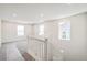 Bright hallway with staircase, neutral paint, carpeted floors, and natural light from three windows at 1889 Water Birch Way, Castle Rock, CO 80108