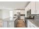 Well-equipped kitchen with stainless appliances, granite countertops, and a stylish island for meal preparation and gathering at 1889 Water Birch Way, Castle Rock, CO 80108