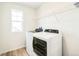 Bright laundry room features a washer, dryer, wood floor, and storage shelving at 1889 Water Birch Way, Castle Rock, CO 80108