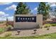 A sign for Terrain, a community in Castle Rock, CO, surrounded by lush landscaping and blue sky at 1889 Water Birch Way, Castle Rock, CO 80108