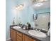 Bathroom showcasing a dual sink vanity with a large mirror, accompanied by a shower and tub at 4451 S Ammons St # 4-108, Littleton, CO 80123
