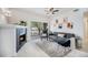 Comfortable living room features a sleek fireplace, plush seating, and natural light from the sliding glass door at 4451 S Ammons St # 4-108, Littleton, CO 80123