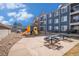 Bright playground including a playset, seating, and community building in the background at 4451 S Ammons St # 4-108, Littleton, CO 80123