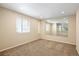 The basement is spacious and well-lit, with a large mirror adding depth to the room at 4860 W 125Th Ave, Broomfield, CO 80020