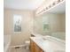 Bathroom with a bathtub and dual sink vanity with neutral countertops and cabinets at 4860 W 125Th Ave, Broomfield, CO 80020