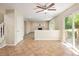 Open dining area featuring tile flooring and access to the deck with views of the cozy living room at 4860 W 125Th Ave, Broomfield, CO 80020