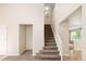 Bright entryway with staircase, white trim and neutral walls, and a view into an adjacent room at 4860 W 125Th Ave, Broomfield, CO 80020