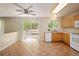 Bright kitchen with tile flooring, light wood cabinets, and sliding doors leading to the outdoor deck at 4860 W 125Th Ave, Broomfield, CO 80020