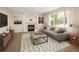 Cozy living room featuring a fireplace, neutral tones, large windows, and stylish decor for a relaxed atmosphere at 4860 W 125Th Ave, Broomfield, CO 80020